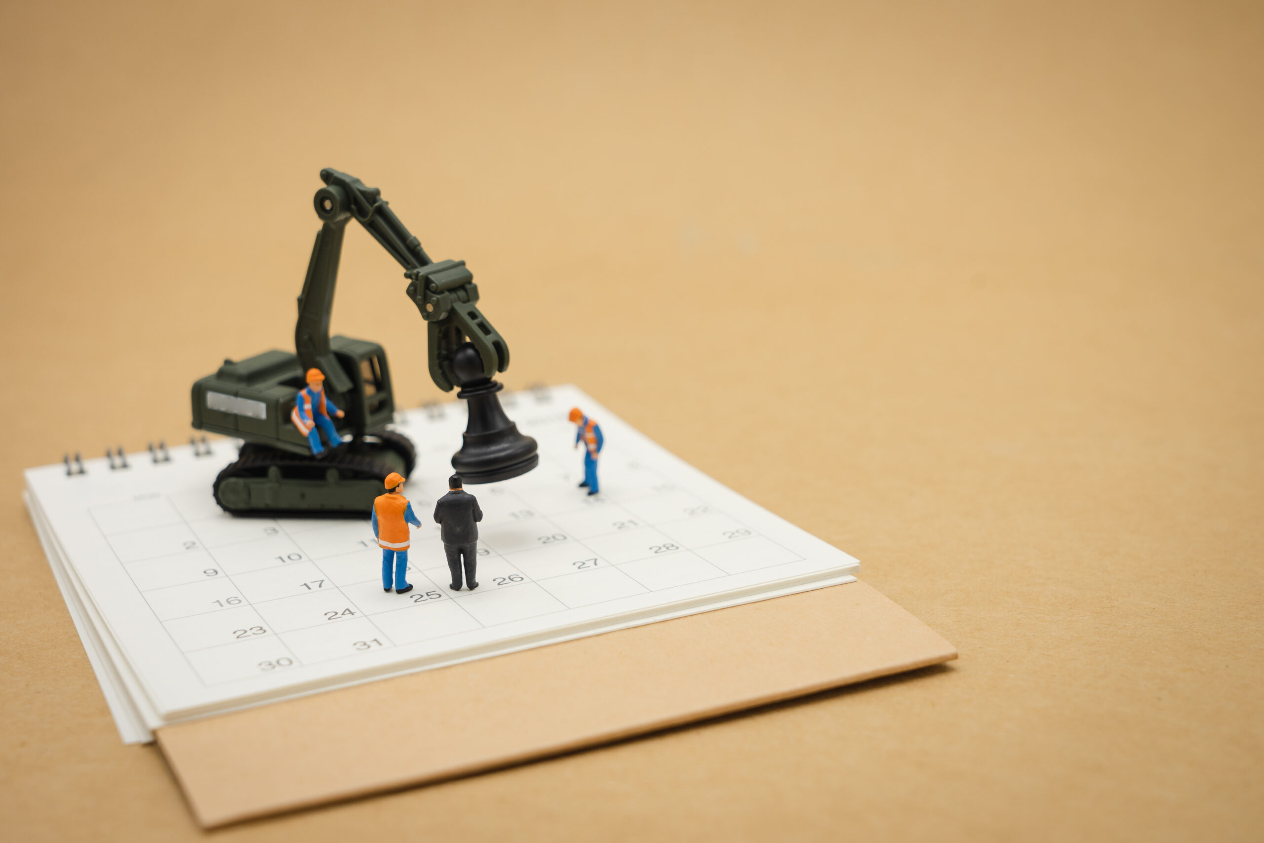 Miniature people Construction worker repair with white calendar