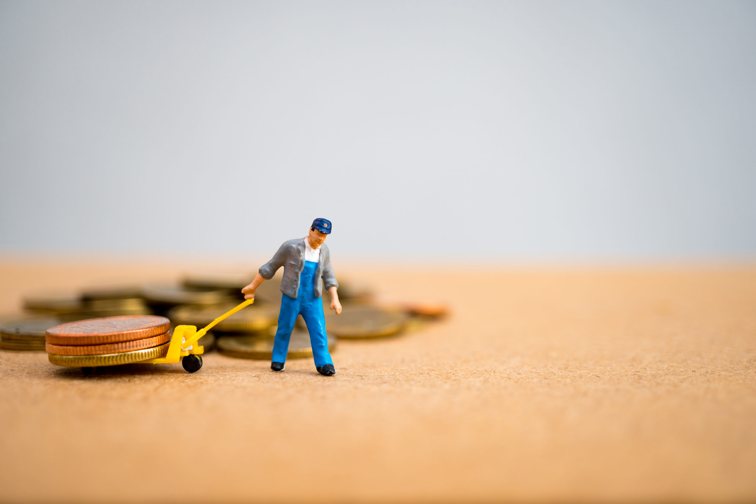 Miniature people, man pulling stack coins, using for logistic, b
