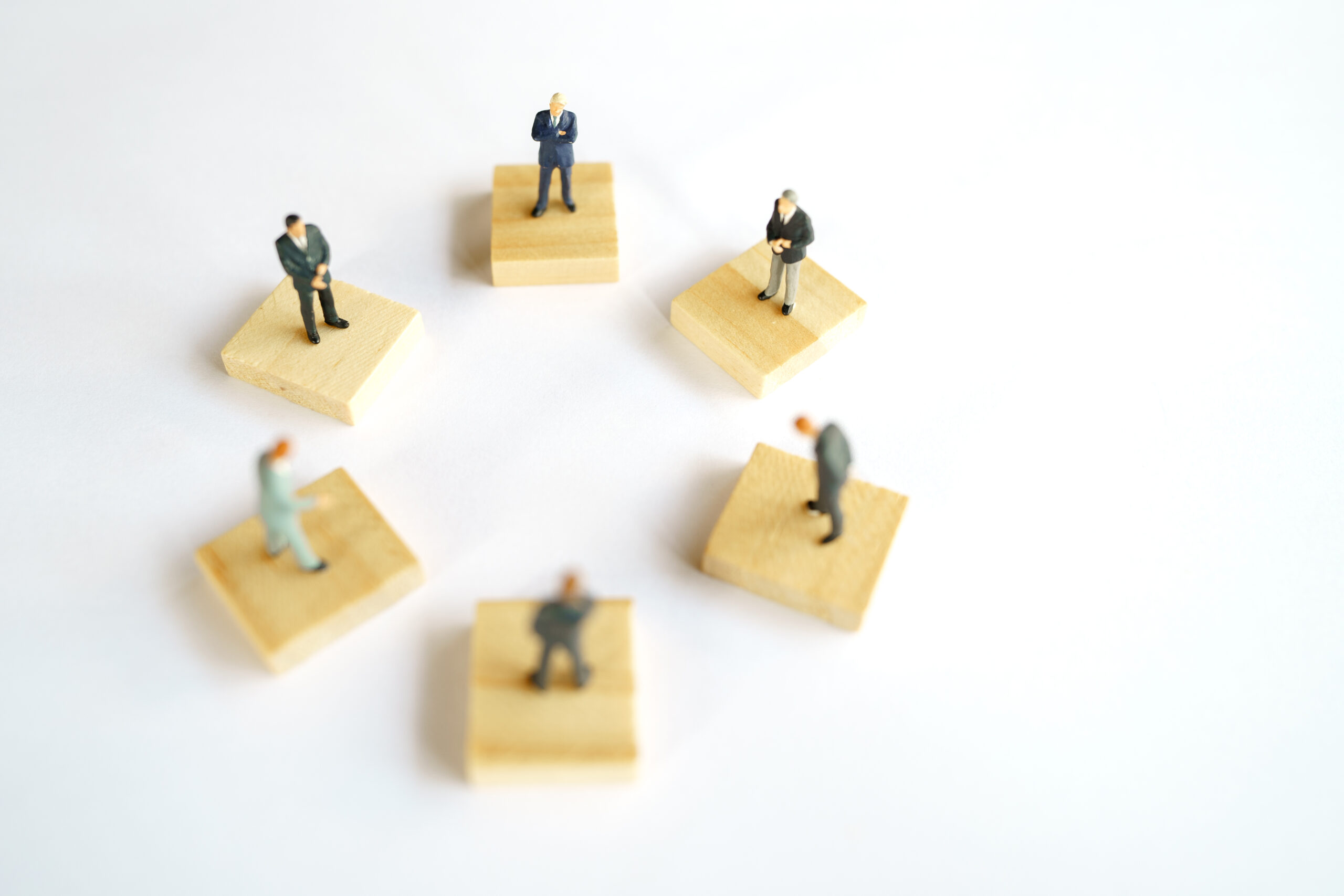 Social distancing. Miniature people stay apart to reduce Covid 1